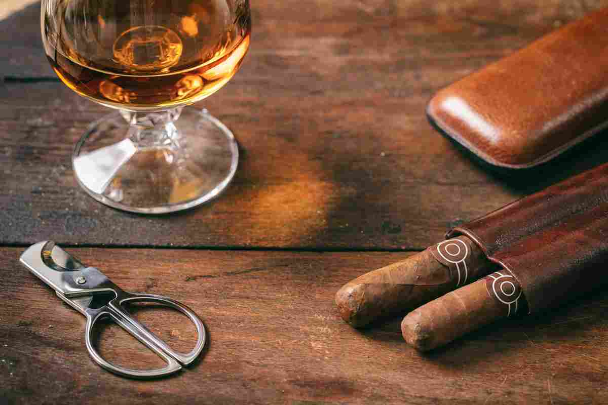 cuban-cigars-closeup-on-wooden-desk-blur-glass-of-2022-12-16-12-08-37-utc